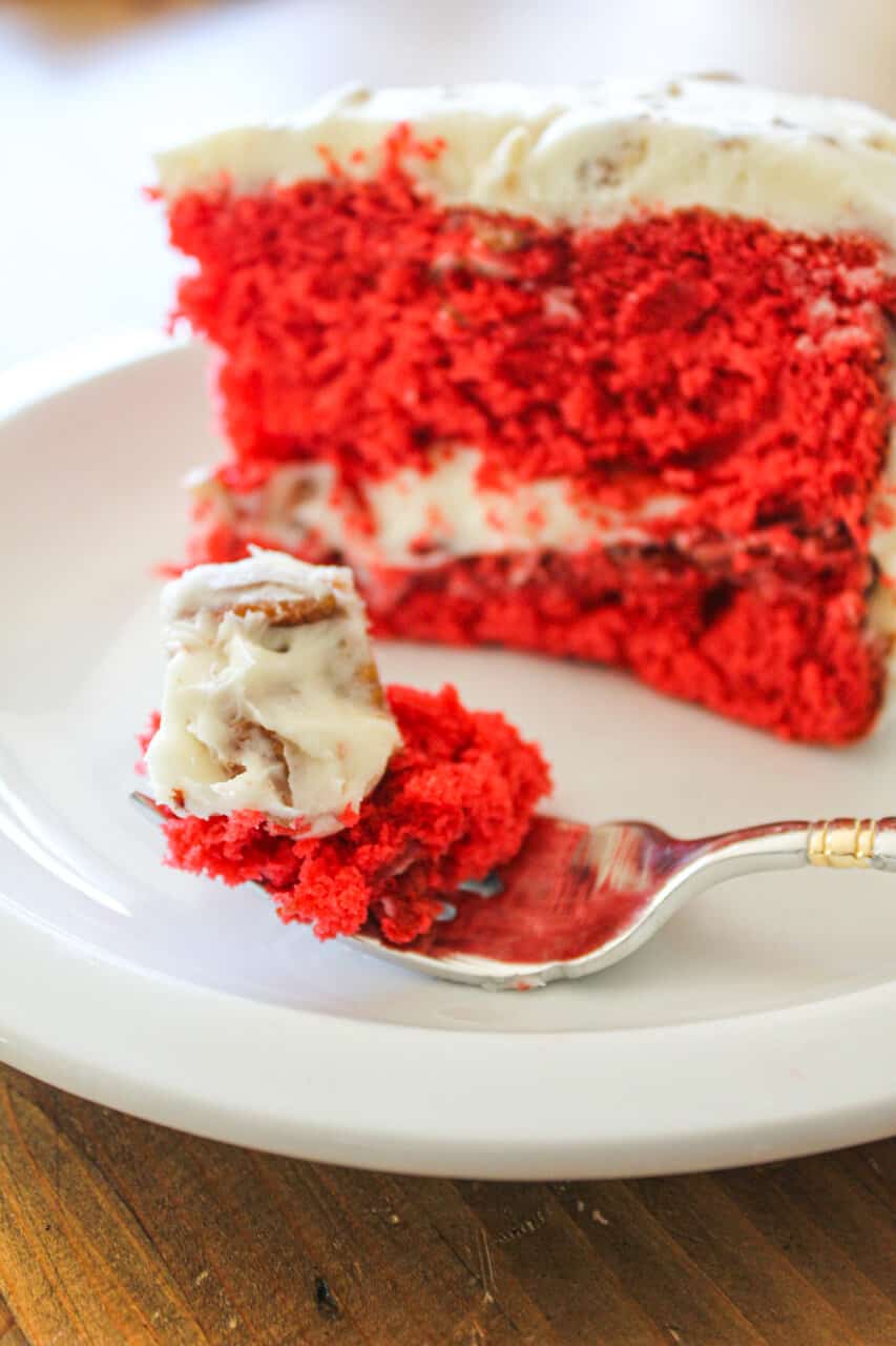red velvet cake sliced to show red center with a bite ready on a fork