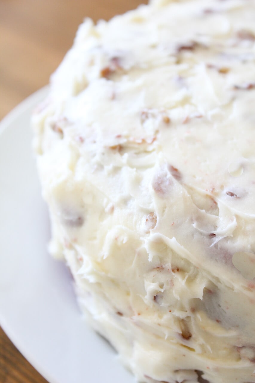 Iced red velvet cake with cream cheese frosting with pecans