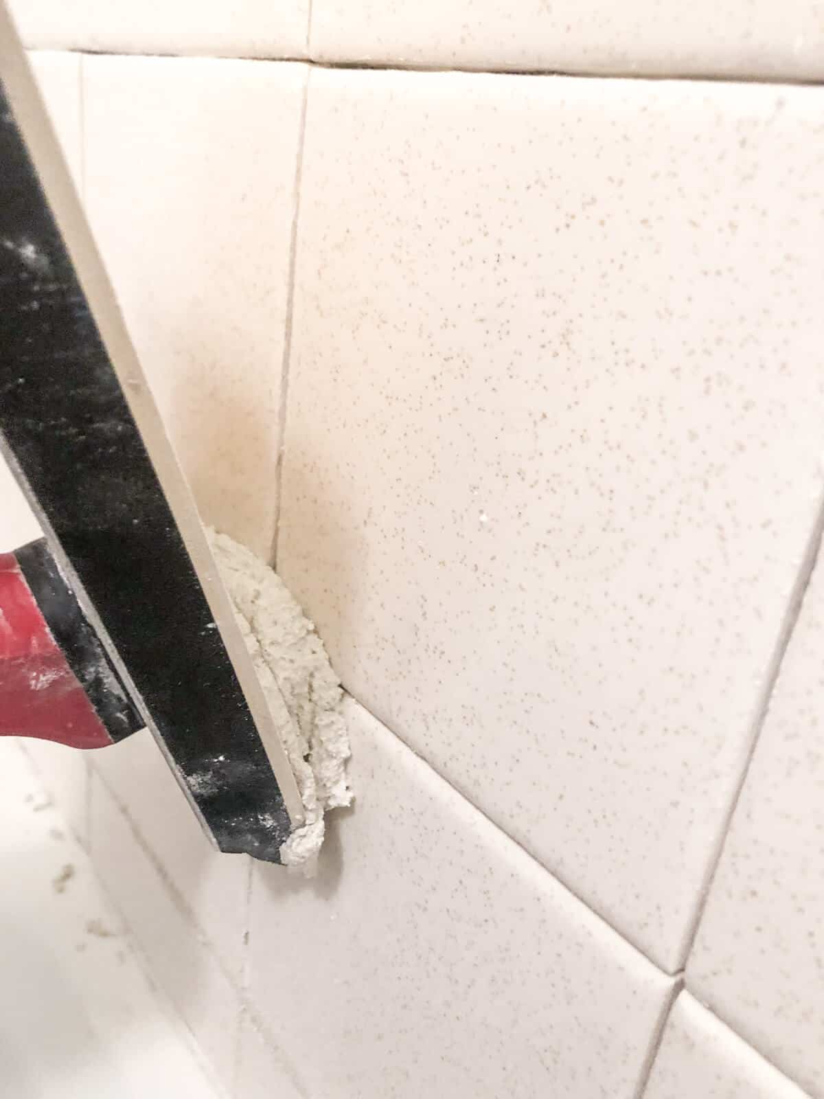apply grout to tile with a rubber float