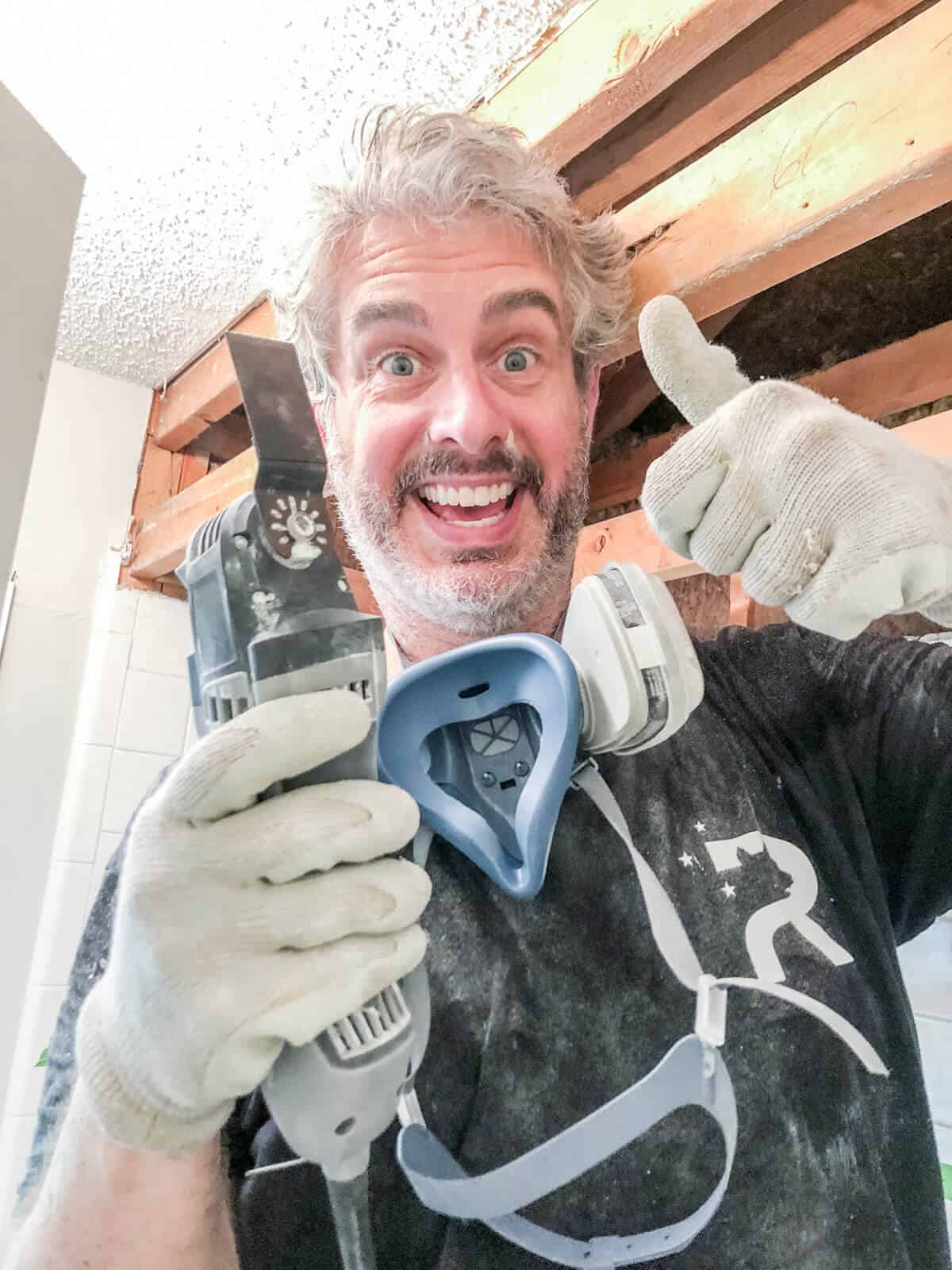 man holding Dremel multi max tool giving a thumbs up