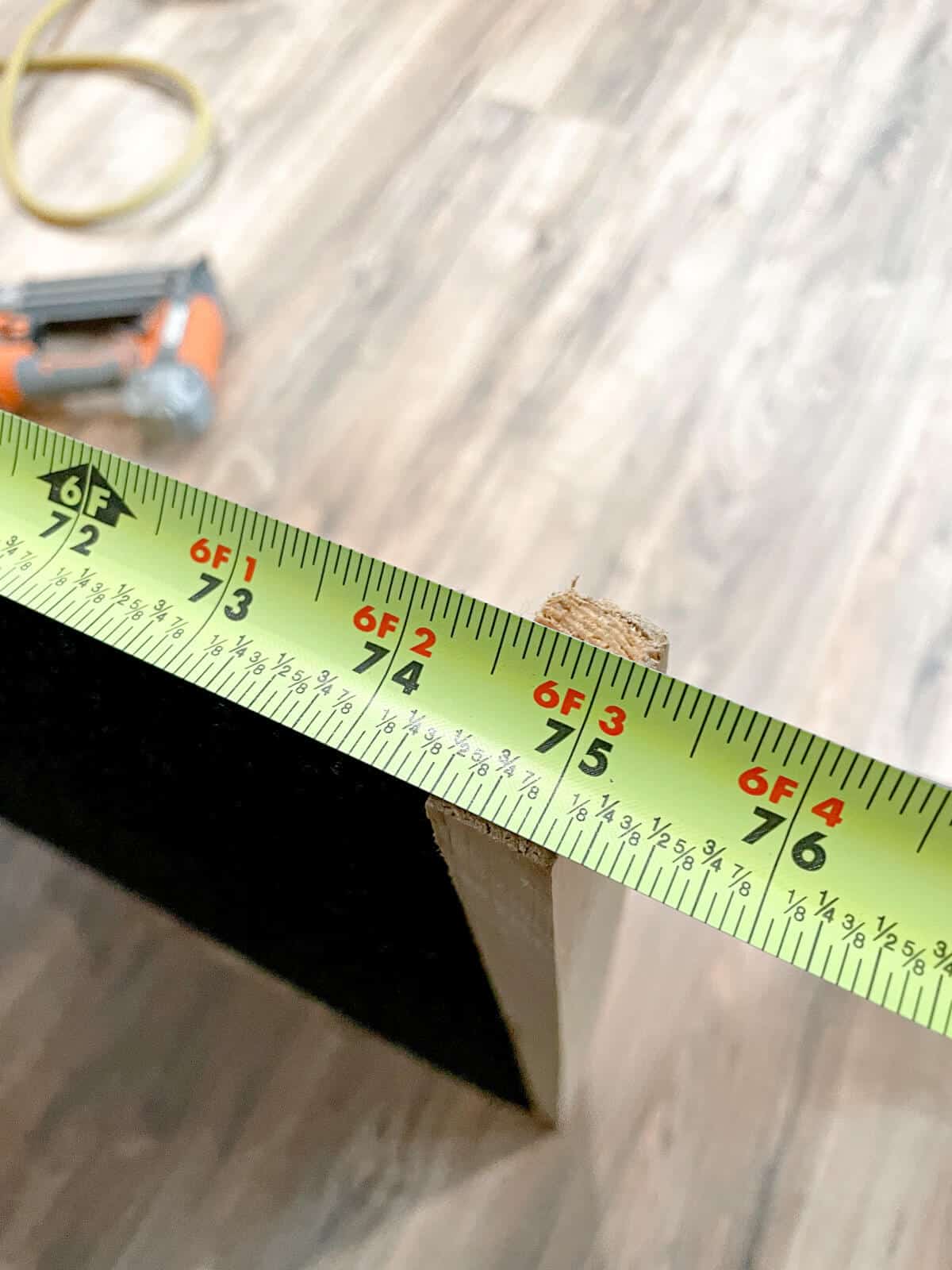 measuring tape showing length of wall panel
