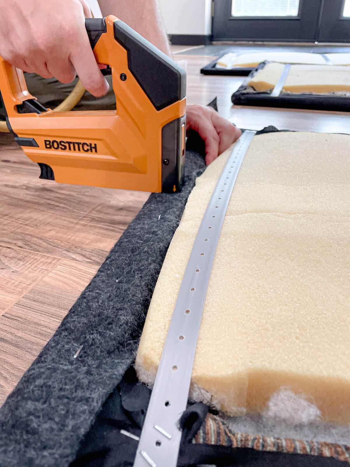 stapling fabric to a wall panel