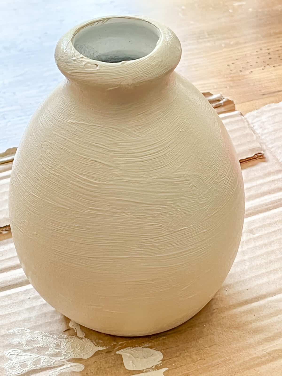 painting a ceramic jar with textured baking soda paint