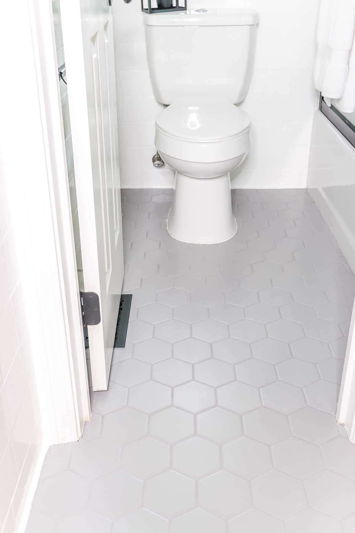 close up of hexagonal tile floor painted with rust oleum home