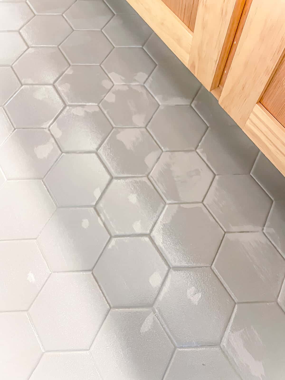 close up of hexagonal tile floor painted with rust oleum home touch ups