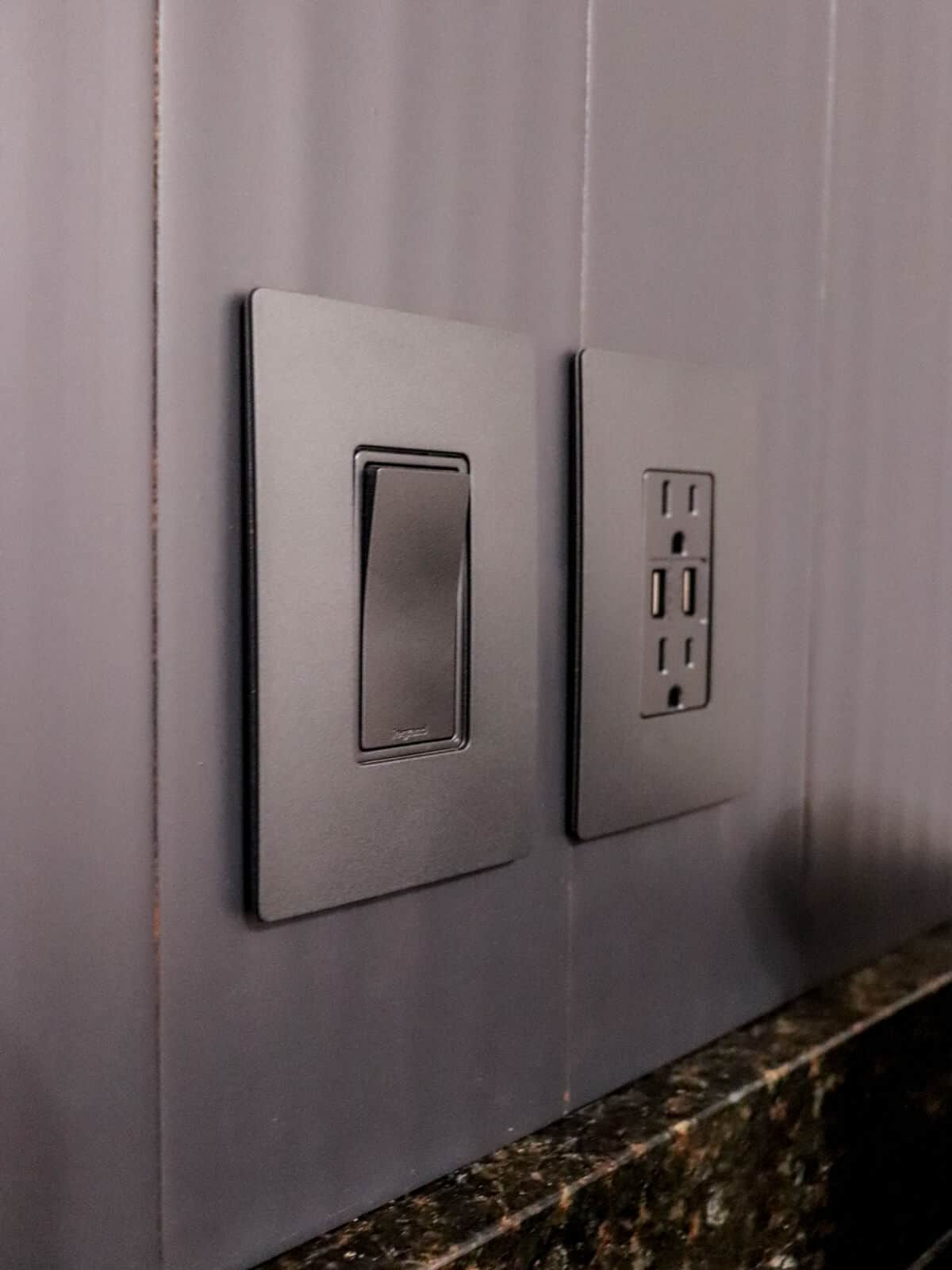 gray backsplash with matching outlets