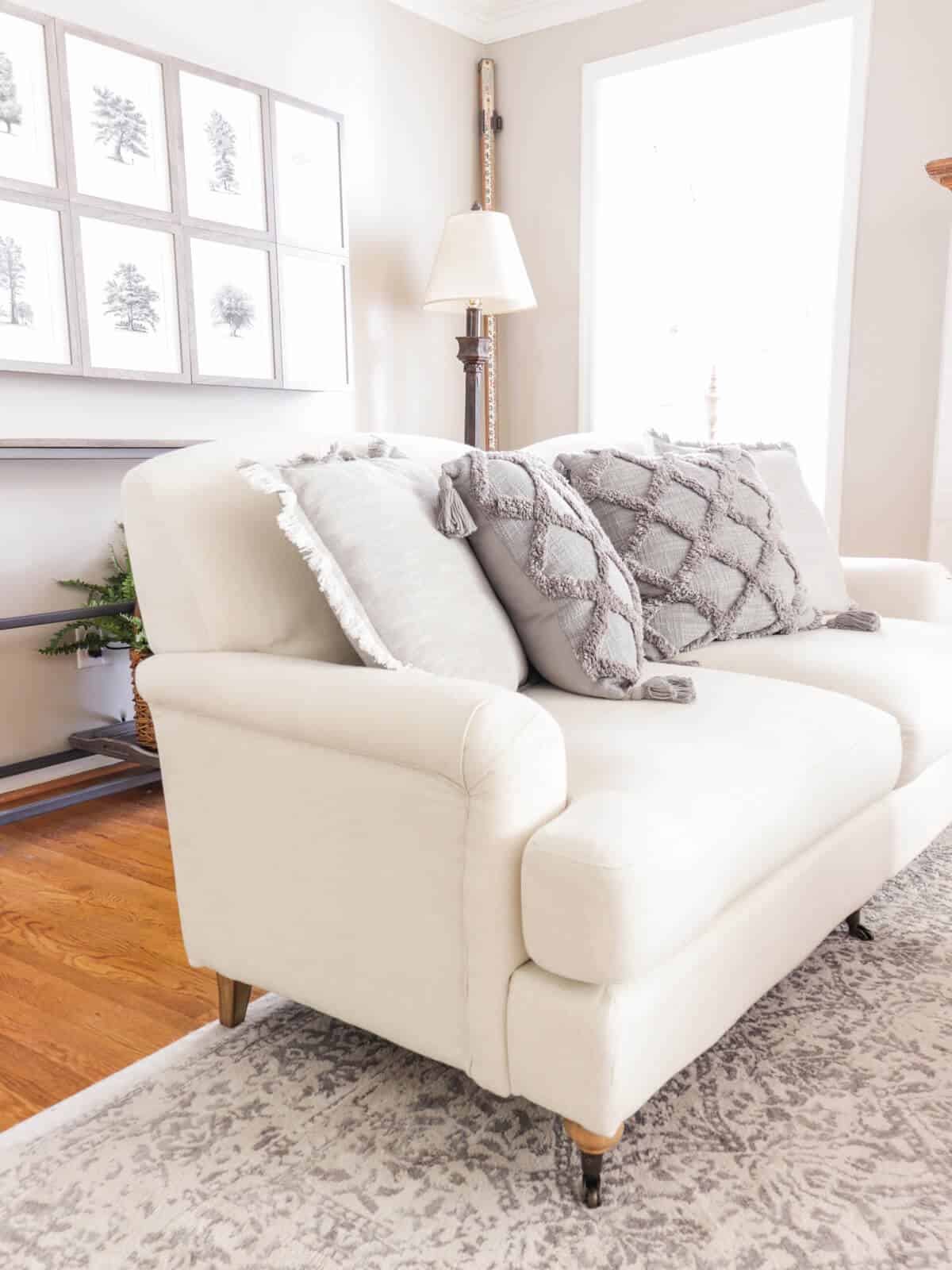cream colored couch with gray pillows