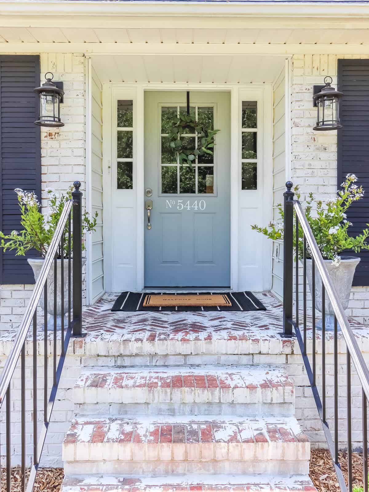 light gray front door with diy target dollar spot wreath and layered door mats
