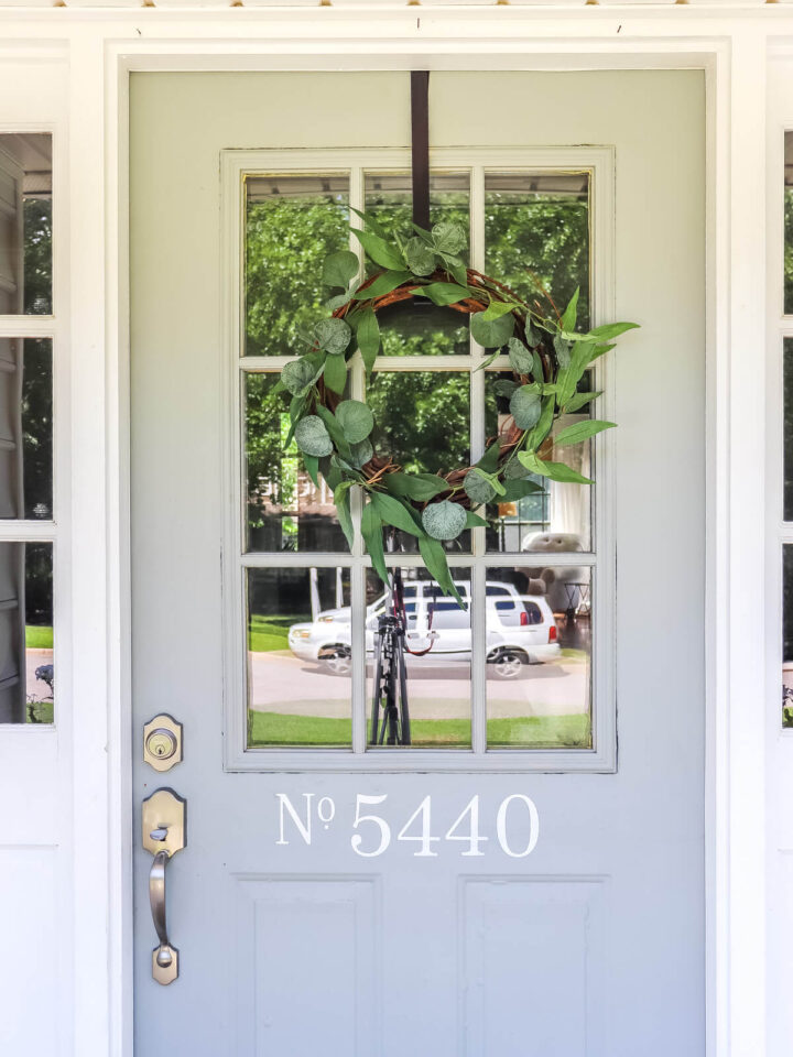 light gray front door with wreath
