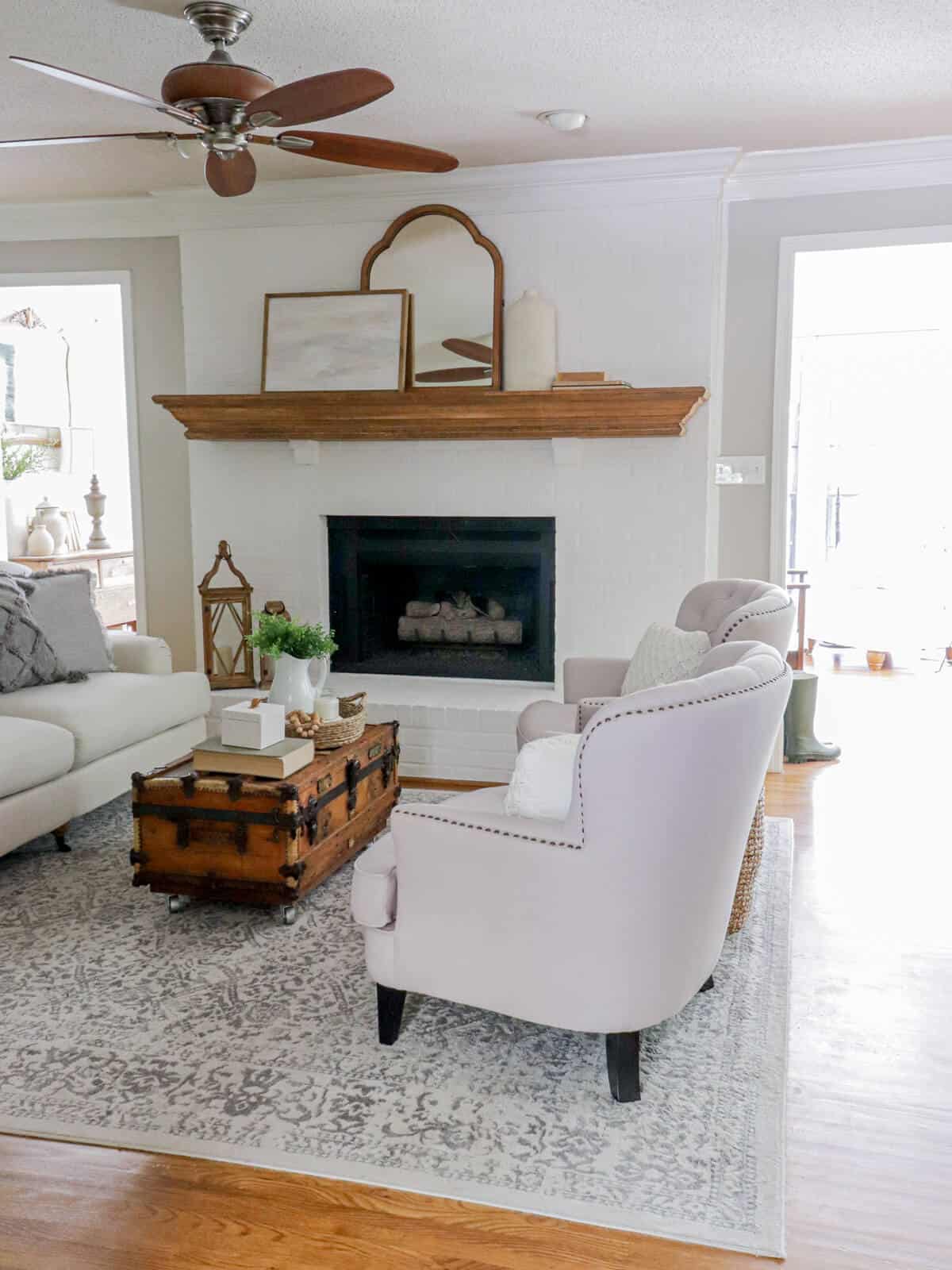 living room styled for summer with whites, wood grains and grays