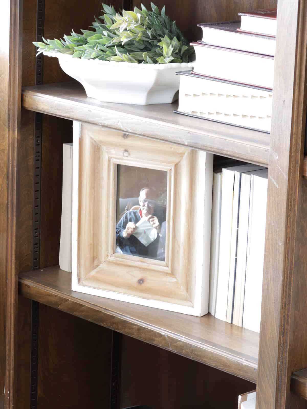 picture frame on a bookcase