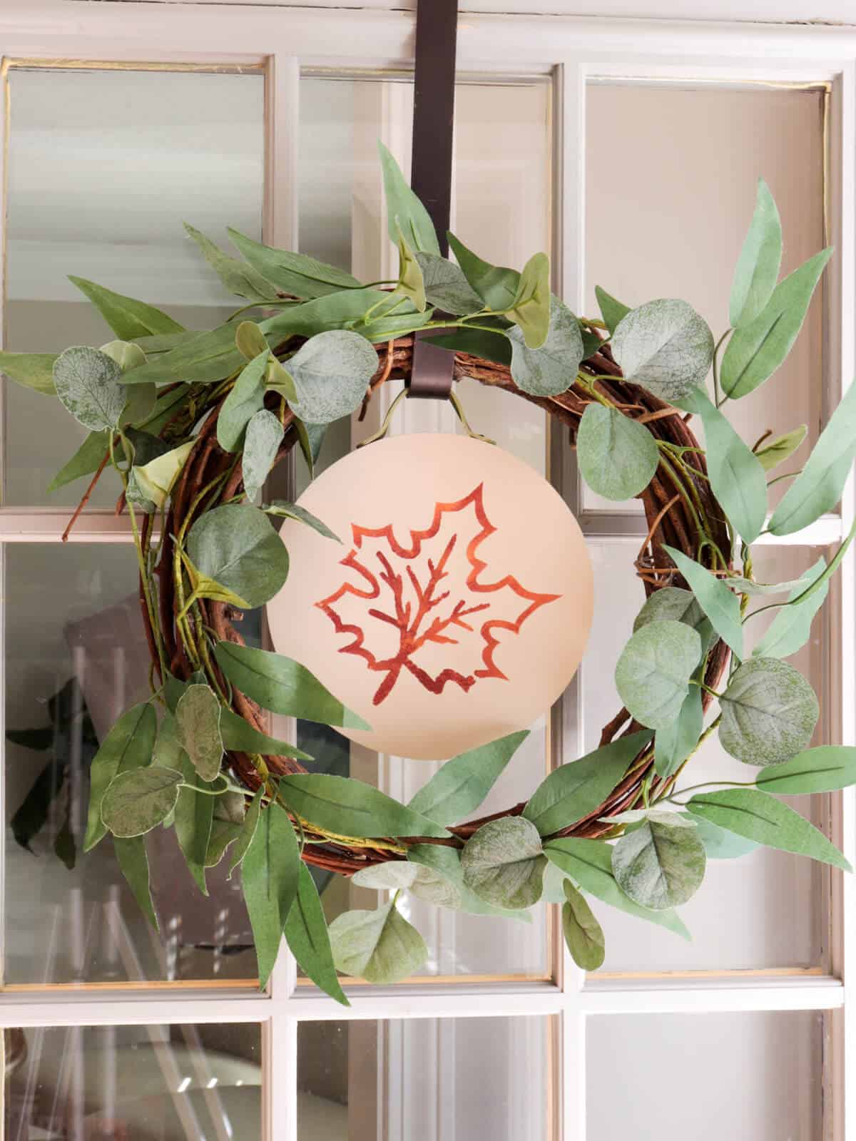 door wreath with an easy seasonal interchangeable disc with a fall leaf