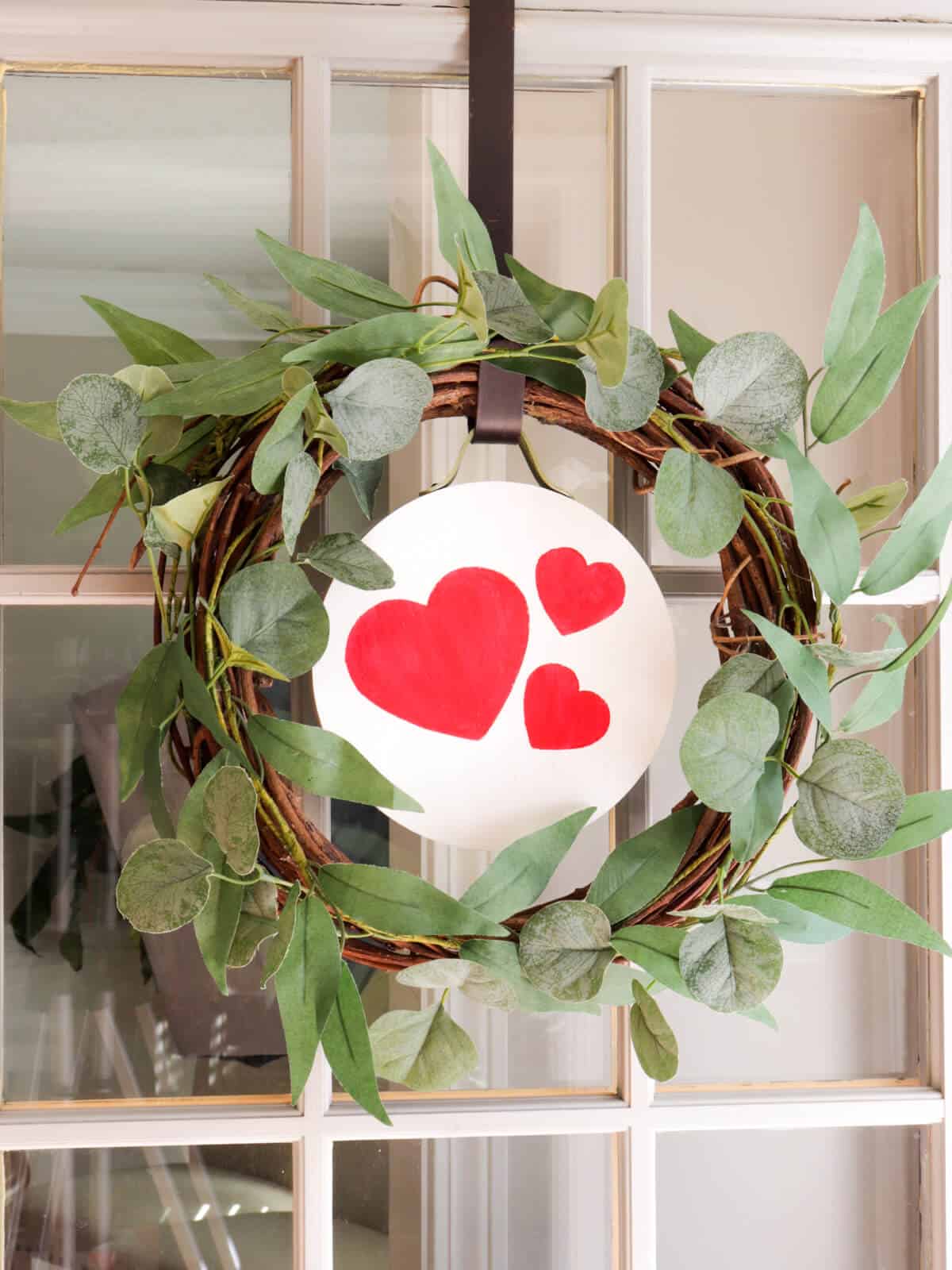 door wreath with an easy seasonal interchangeable disc with hearts