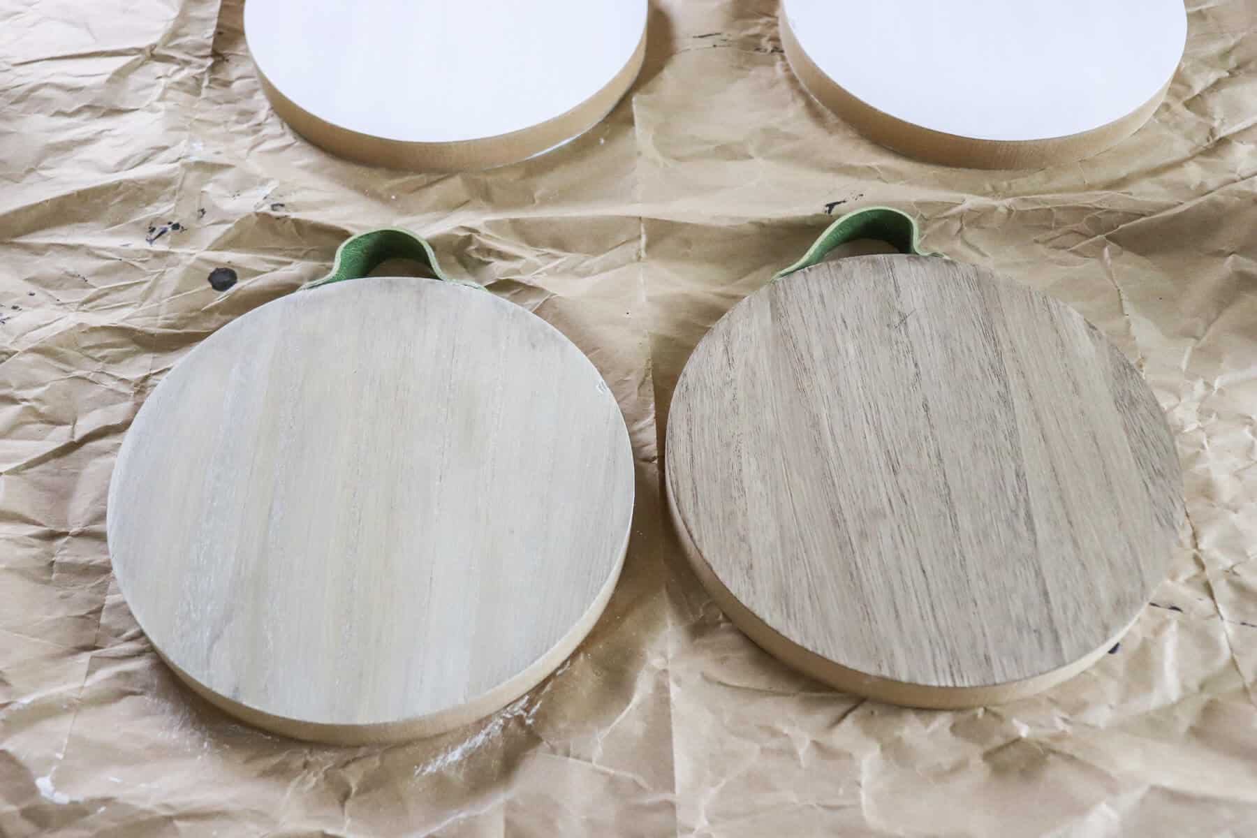 two wood discs, both stained and one lime washed