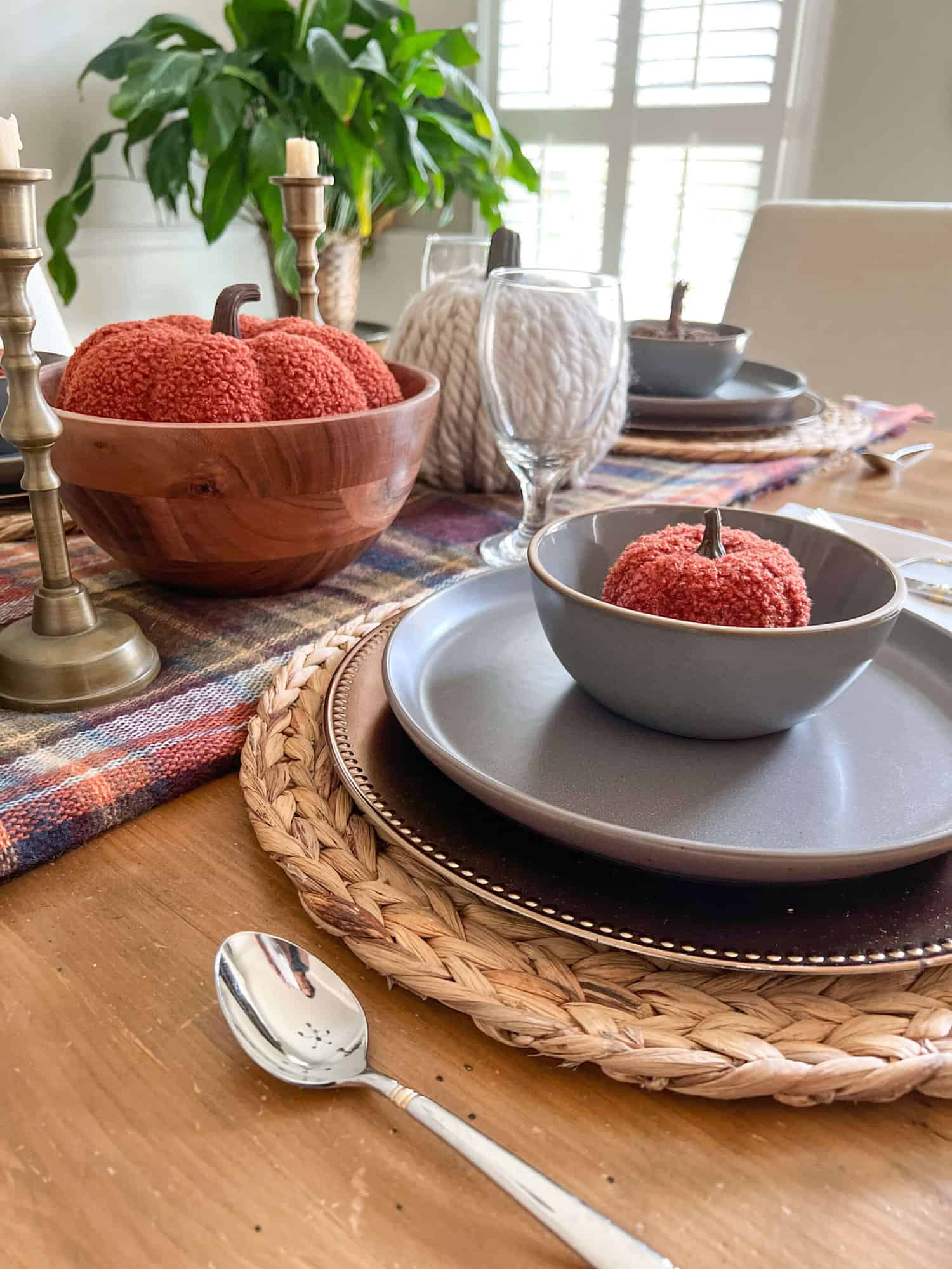 simple thanksgiving tablescape with gray plates and dark orange pumpkins