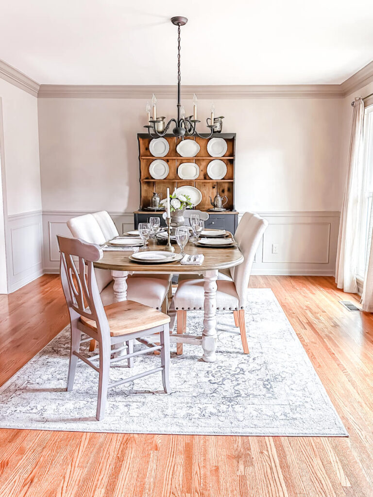 Dining room with farmhouse table and painted hutch