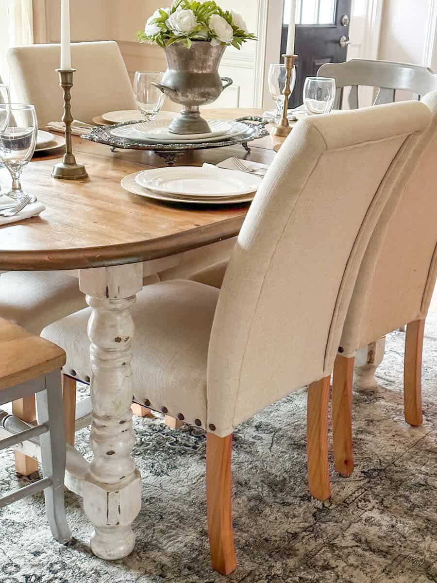 linen chairs next to a farmhouse dining table