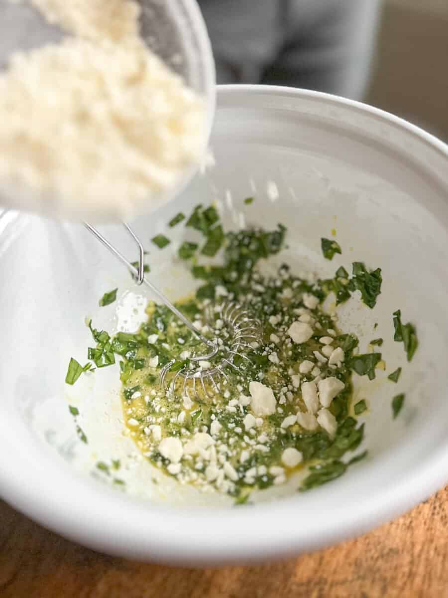 adding feta cheese to egg and spinach mixture