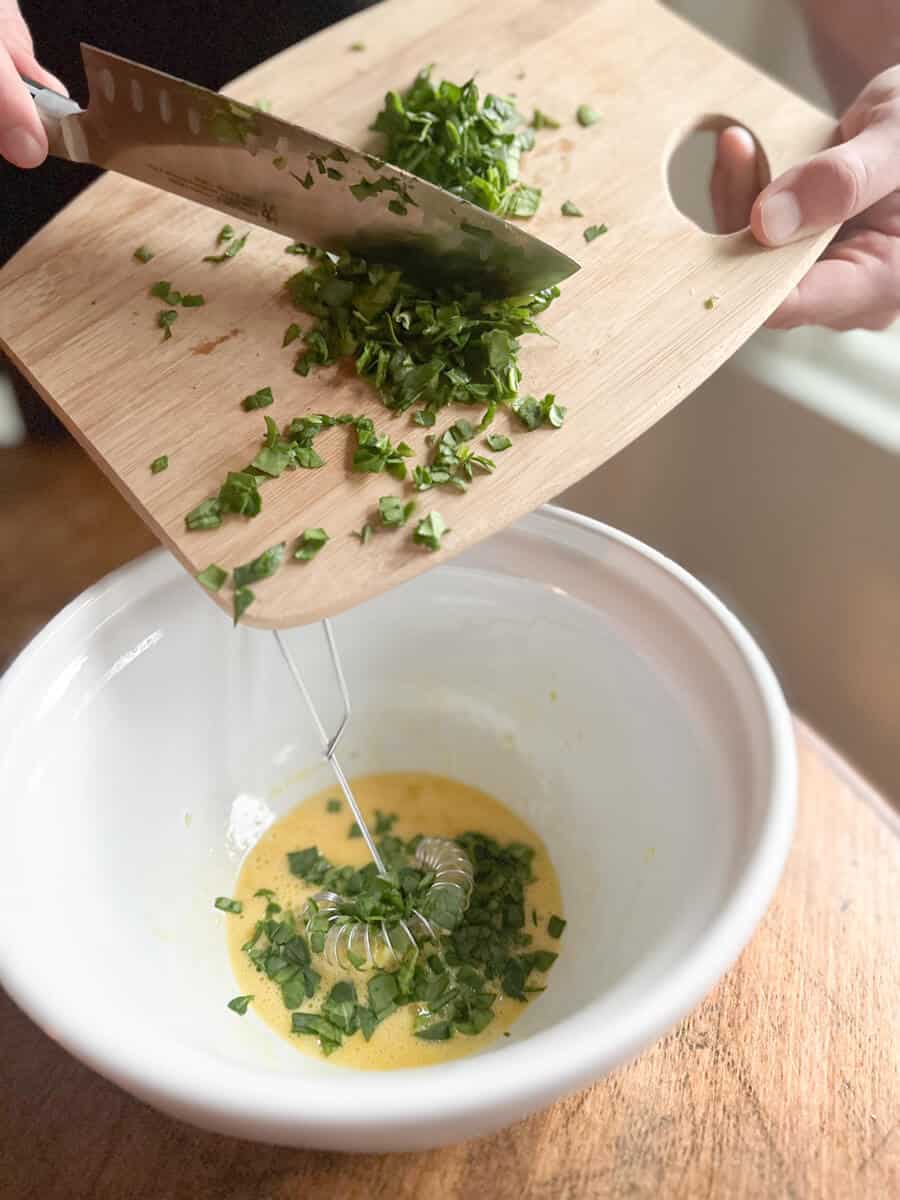 adding spinach to egg mixture