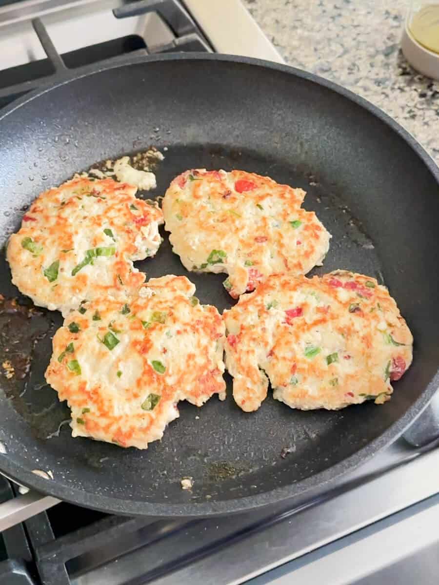 Turkey or chicken burger cooking in a pan