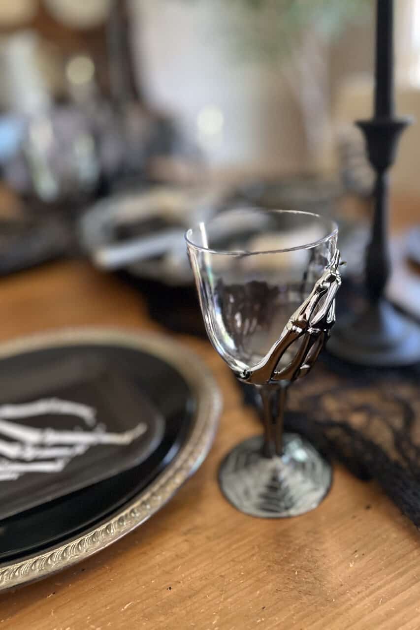 halloween table decor with plastic goblet with silver skeleton hand