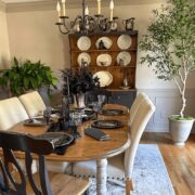 Dining room table decorated for Halloween with spooky black decor