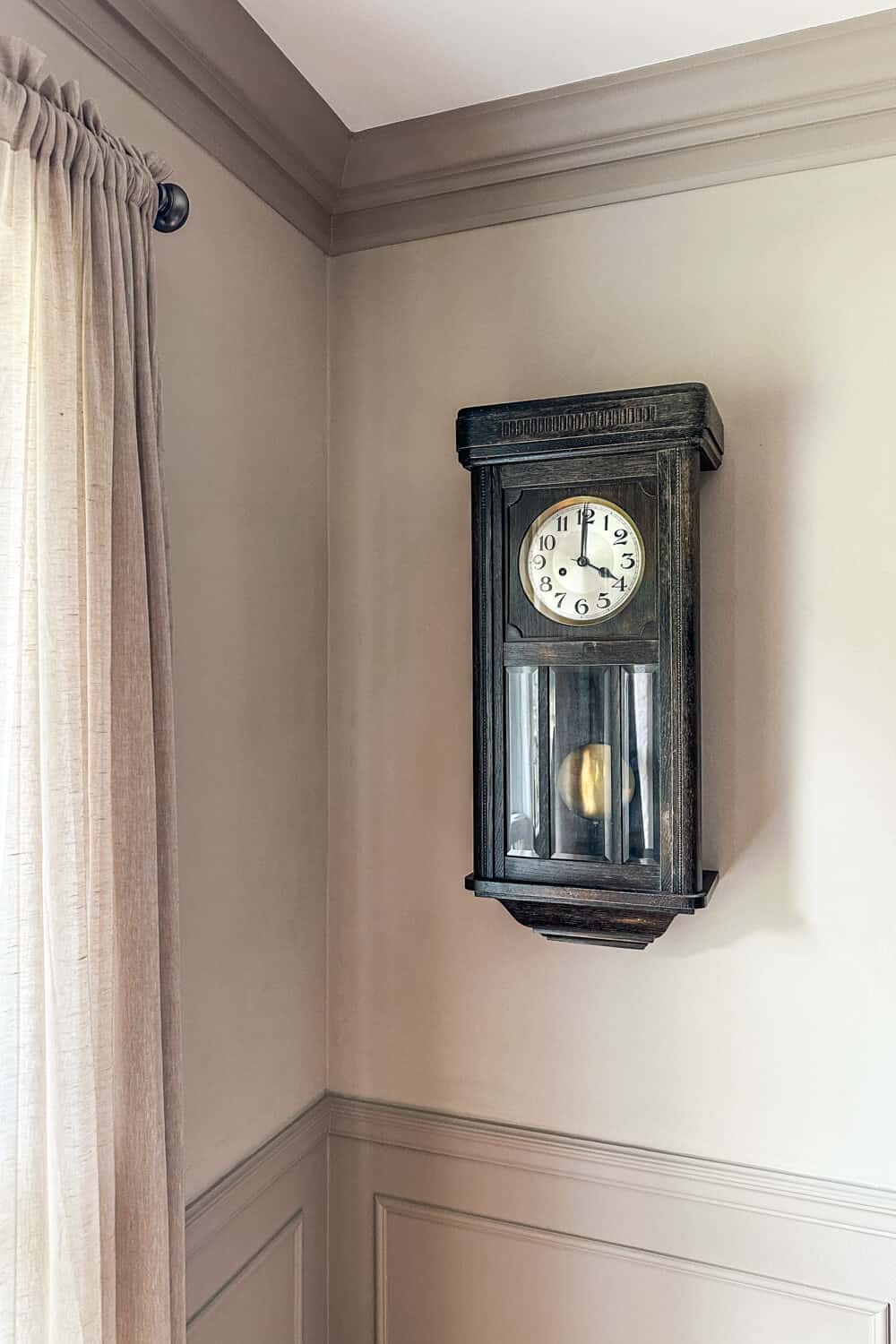 vintage clock hanging on wall with limewash finish