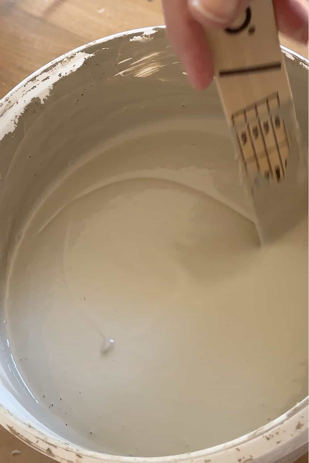 limewash paint in a bucket with stir stick