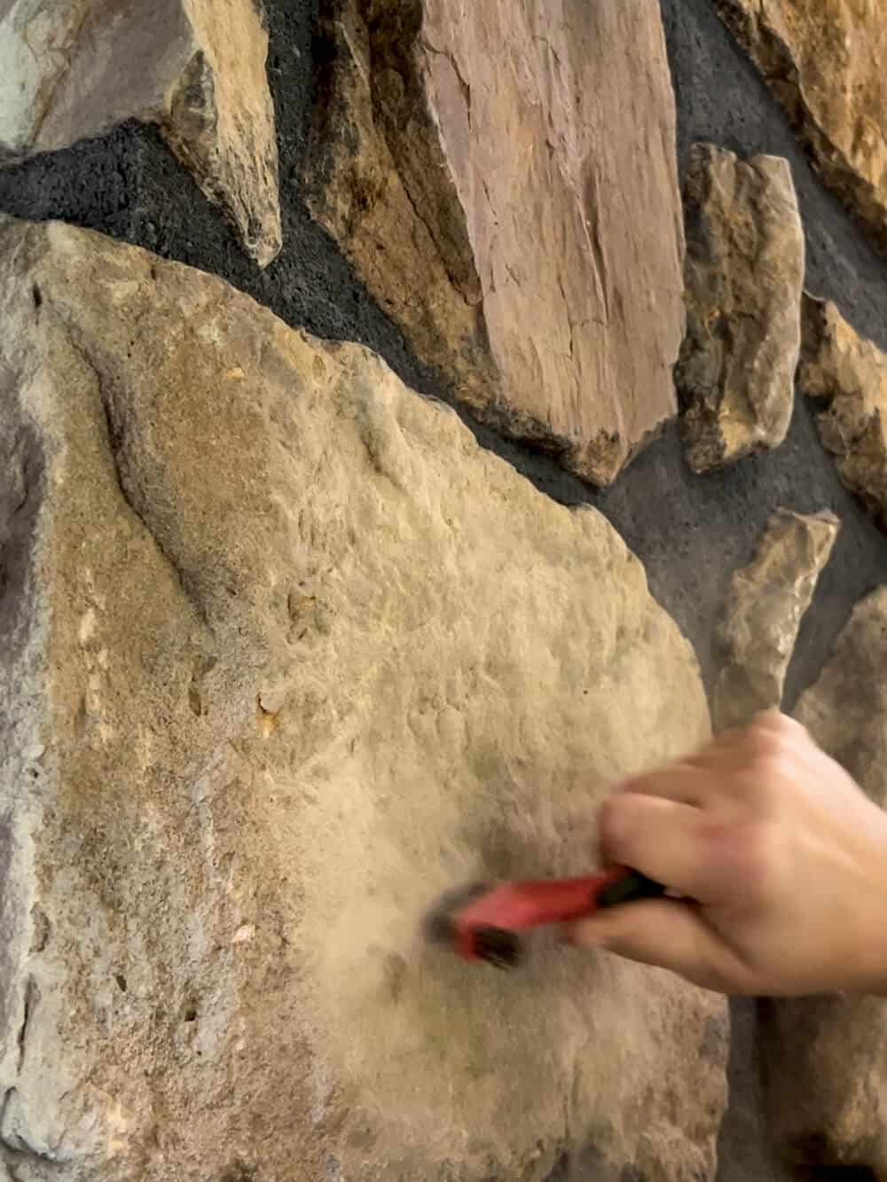 A ladder is sitting on top of a stone fireplace.
